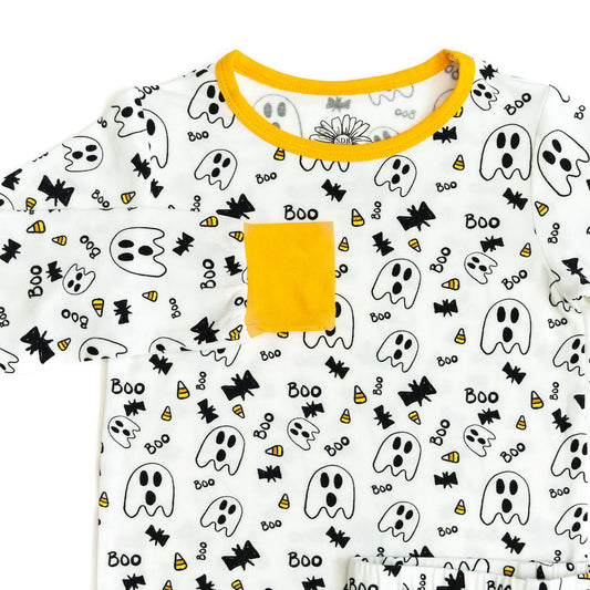 Halloween-themed t-shirt with ghosts, candy corn, and 'boo' text on a white background.
