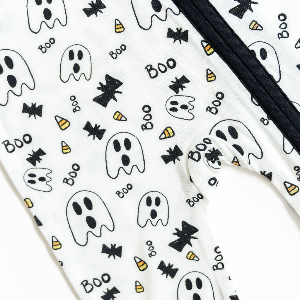 Phone case with Halloween-themed design featuring ghosts, bats, and candy corn on a white background.