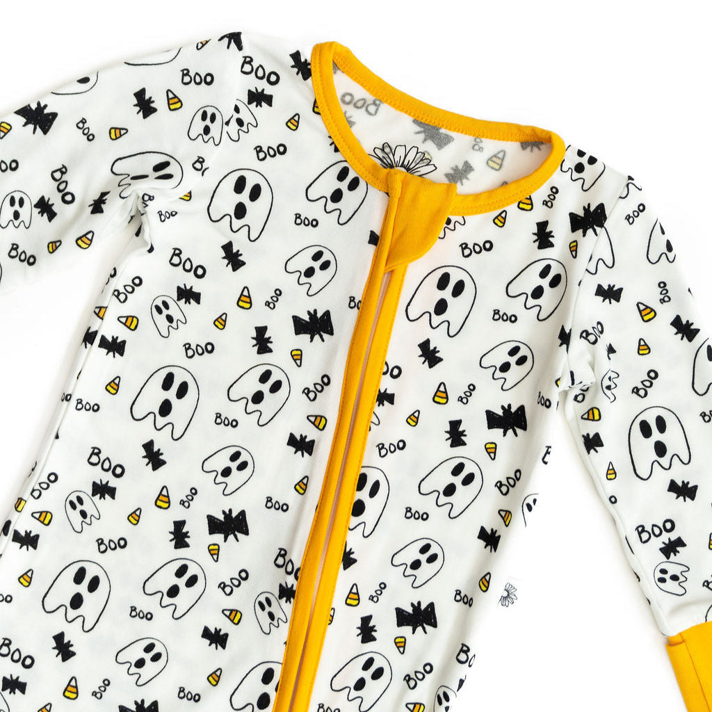 Baby onesie with Halloween ghost pattern and yellow zipper on a white background