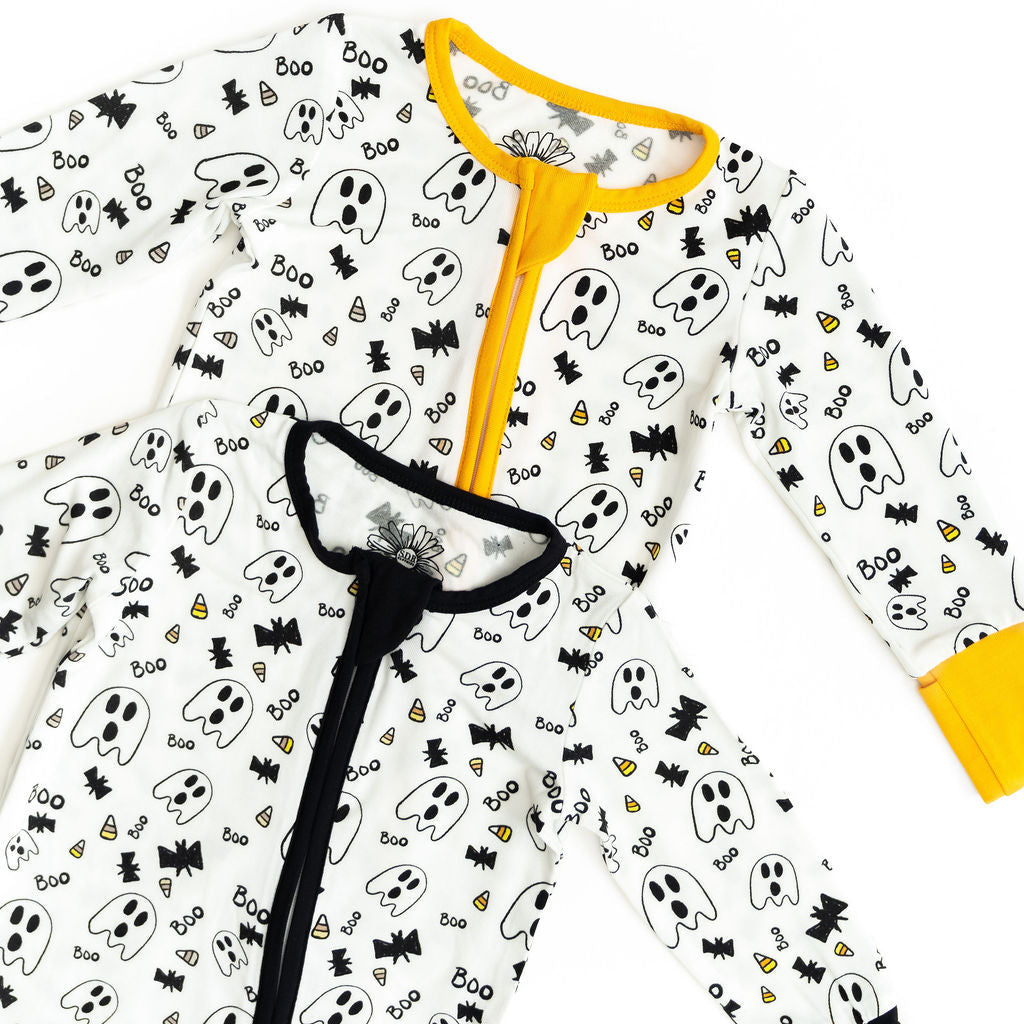 Children's Halloween-themed onesie with ghost and bat pattern on a white background