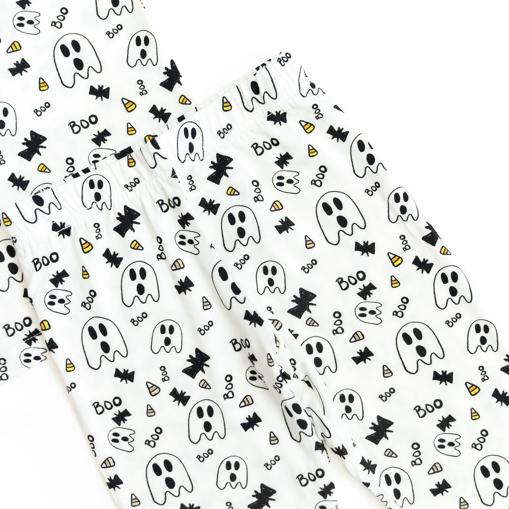 Halloween-themed wrapping paper with ghosts, bats, and candy corn on a white background.